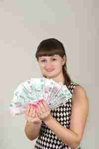 12 Month Payday Loans direct lenders girl holding cash in front of face