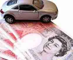 A toy car placed on top of british pound banknotes, possibly representing the concept of automotive expenses or the cost of buying a car in the uk. poor credit car finance