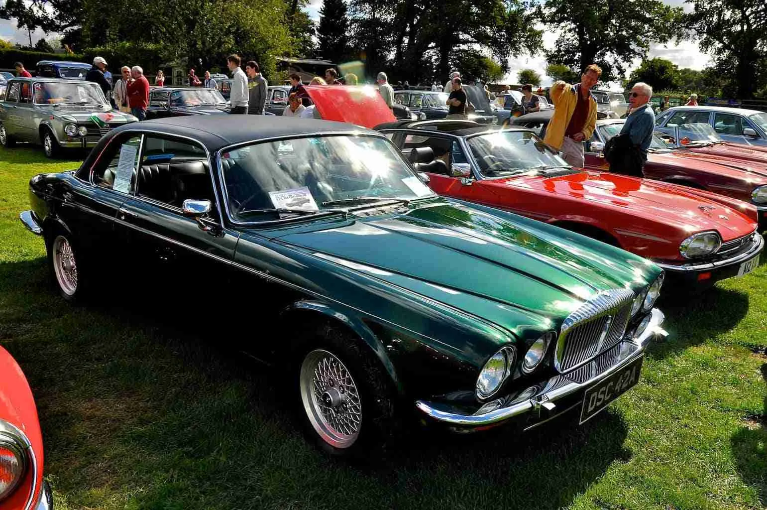 Used Car Financing Bad Credit A classic car show featuring vintage vehicles, including a gleaming green jaguar, with spectators admiring the collection on a sunny day. used car financing bad credit