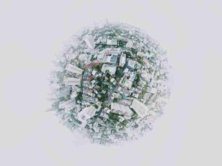 A tiny planet view of an urban landscape, showcasing a 360-degree spherical panorama of city buildings and streets.