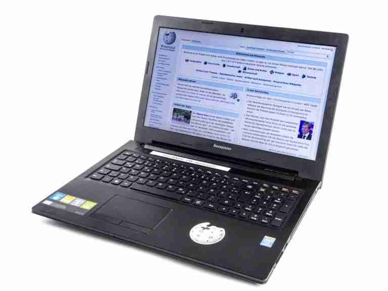 A lenovo laptop displaying a wikipedia page, isolated on a white background.