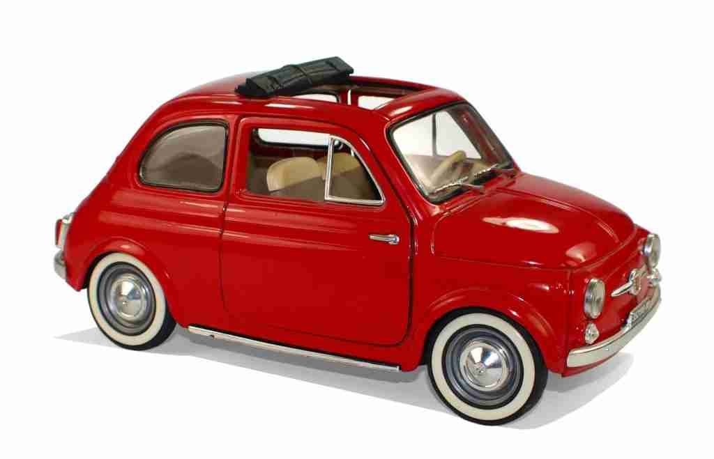 A bright red vintage model car with a sunroof, showcasing classic design and nostalgic charm. 500 pound loans.