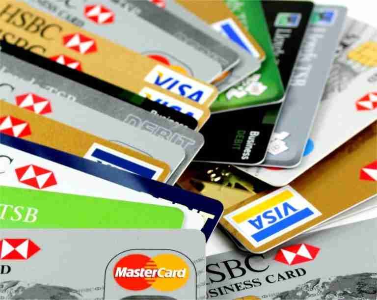 A collection of various credit and debit cards spread out, showcasing multiple bank and payment networks. credit cards