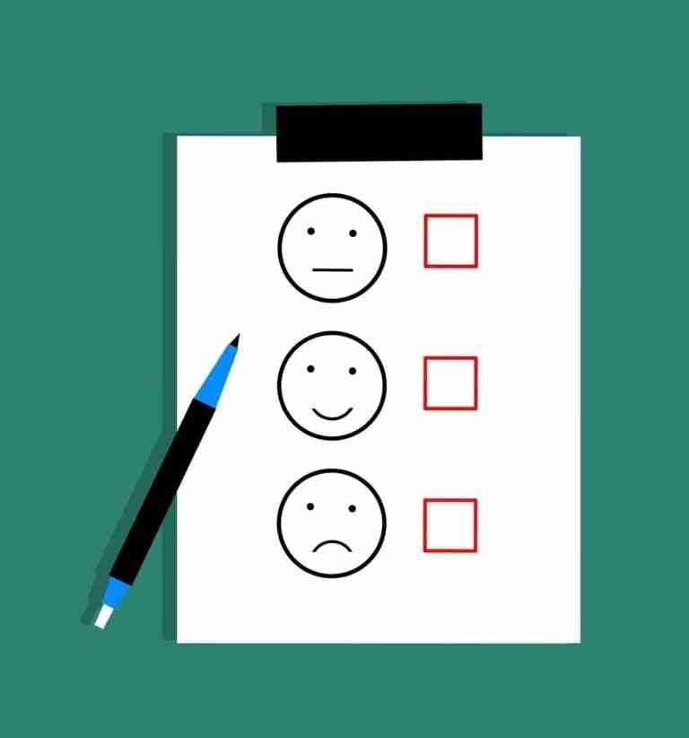A customer feedback form with three smiley face options ranging from happy to sad next to checkboxes, accompanied by a blue pen, implying the need for a response regarding satisfaction level.