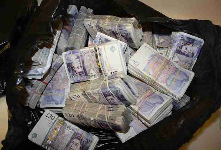 A hefty sum of british pound sterling notes haphazardly packed in a black garbage bag, showcasing a large amount of currency in a very unorthodox storage method. Direct Lender Credit
