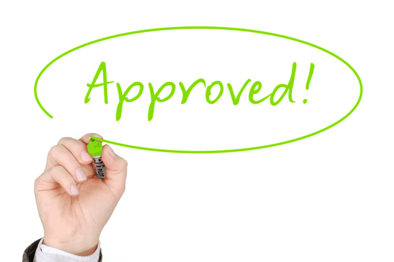 A hand holding a marker having just written the word "approved!" encircled with a vibrant green line on a transparent background.