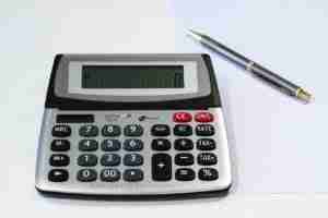 personal loan calculator on desk with pen