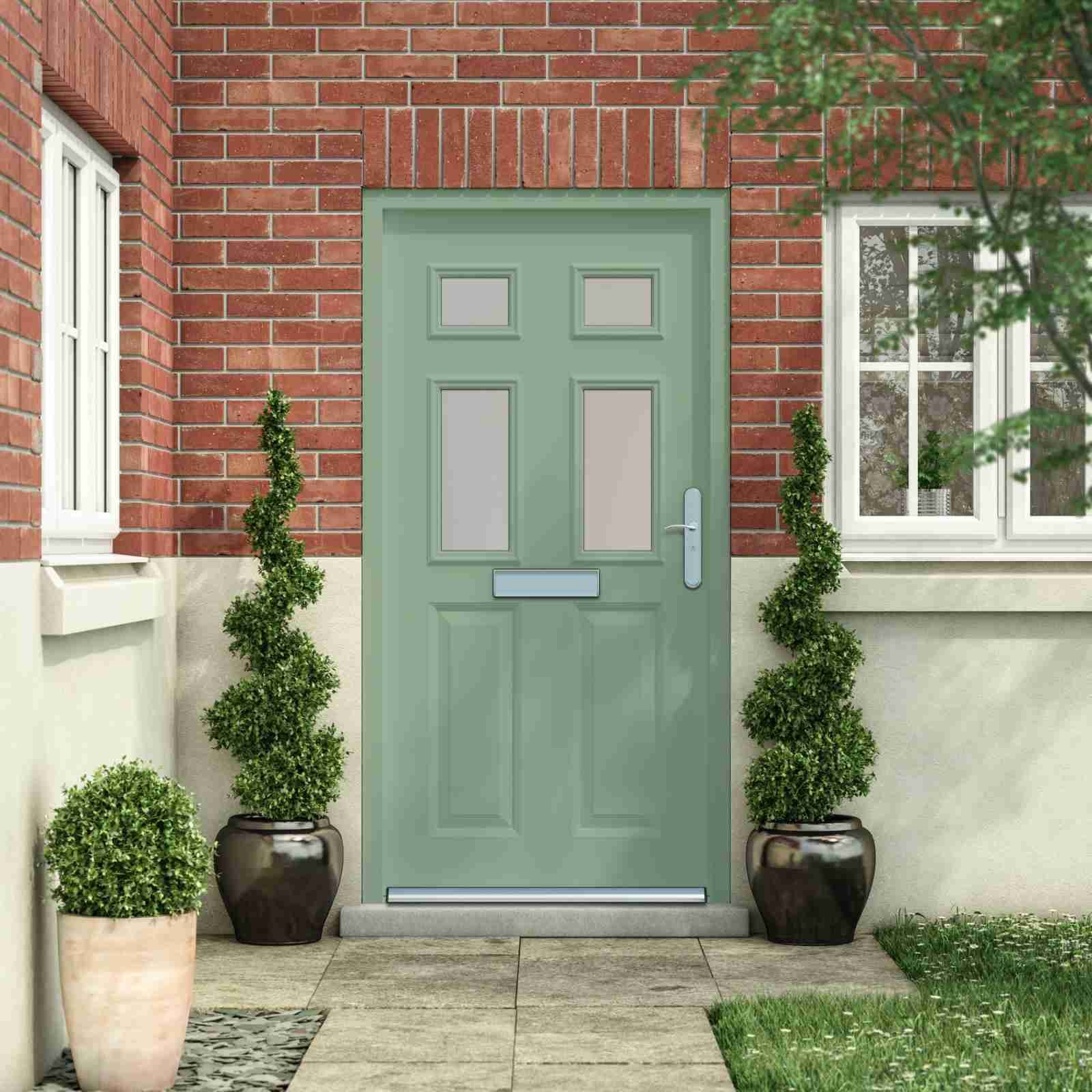 A welcoming pastel green front door of a house with red brick walls, accompanied by two decorative potted plants on either side, leading to a cozy home ambiance. door to door loans