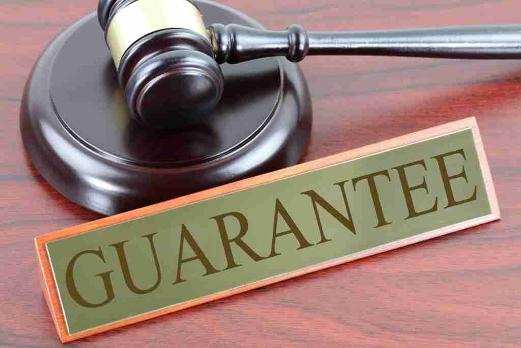 guarantor lenders like amigo hammer and gavel with guarantee sign