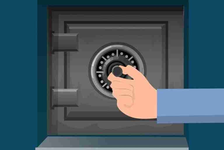 A person's hand turning the combination dial on a safe.