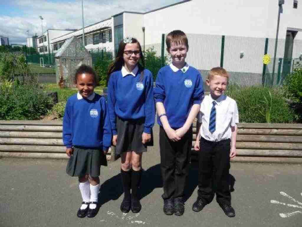 2 girls and 2 boys in school uniform standing in school playground the dreaded back to school after the holidays!