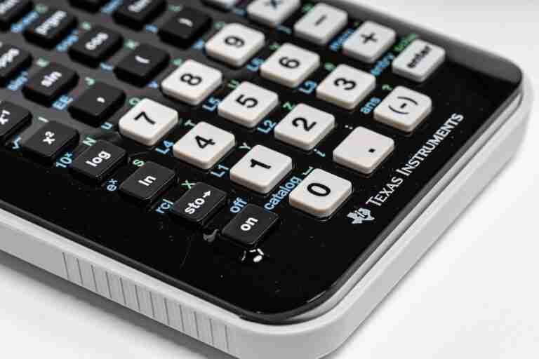 A close-up of a Texas Instruments scientific calculator focusing on the central part of the keyboard with numerical keys and function buttons. 1000 Pound Emergency Loans