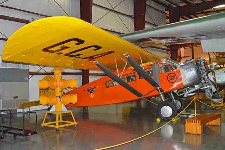 Vintage orange biplane with registration "g-ebqp" on display in a hangar or museum setting, reminiscent of an era when acquiring a 6000 loan bad credit was a conceivable