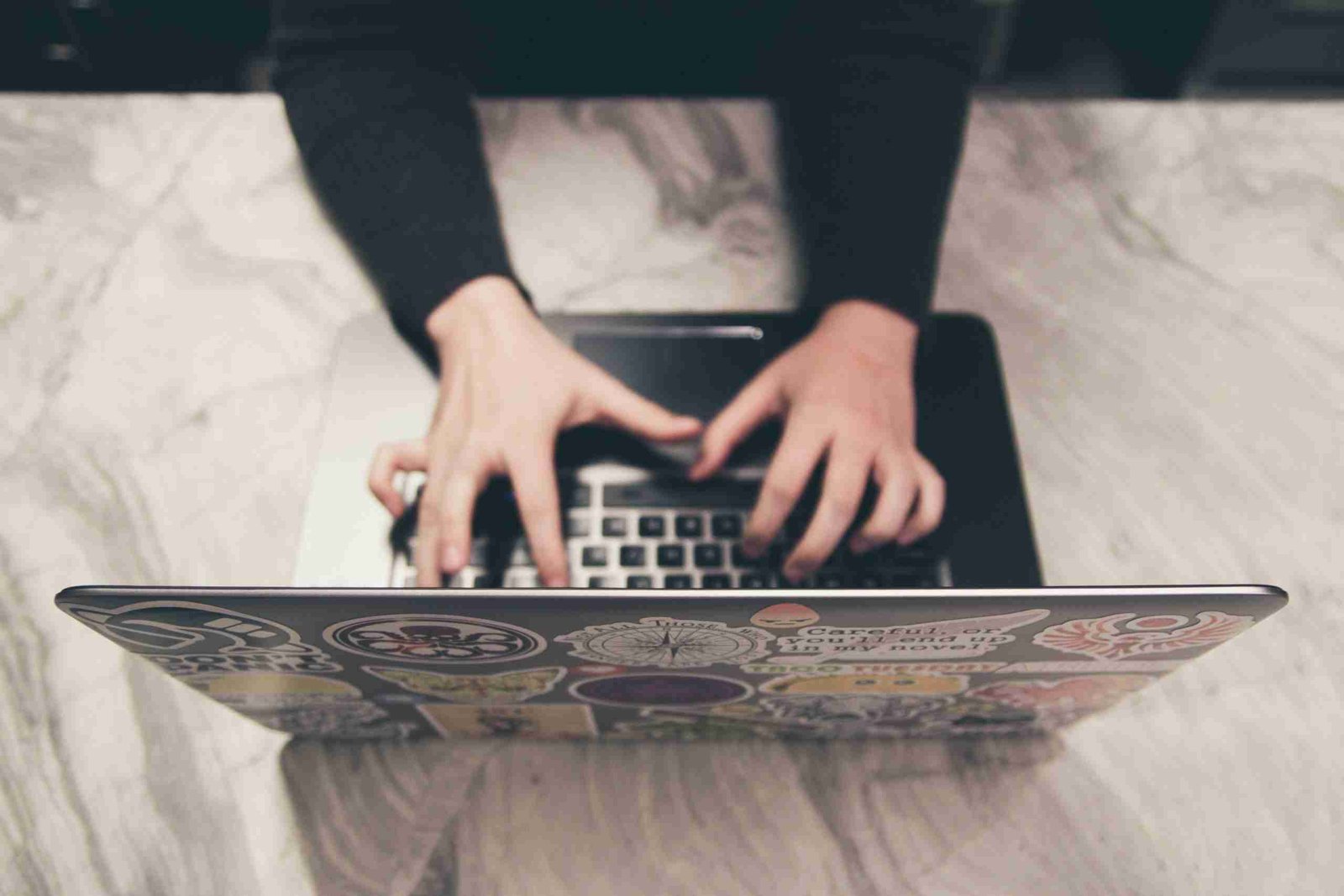 typing on laptop computer