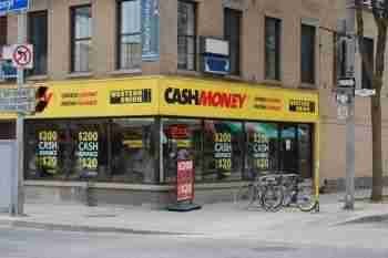 Every Day Loans With Everyday Lenders A street-level view of an "every day loans" store, which offers financial services, with a bold yellow storefront situated on a city street corner.