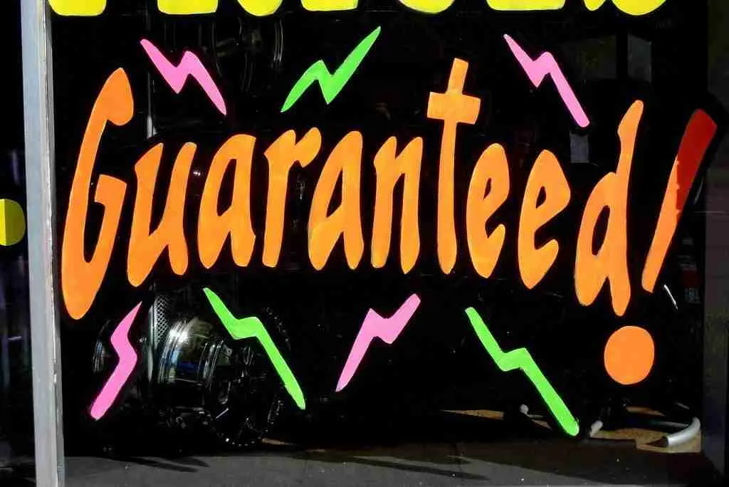 Bold and colorful "guaranteed approval loans bad credit!" sign with dynamic arrows and exclamation for eye-catching emphasis.