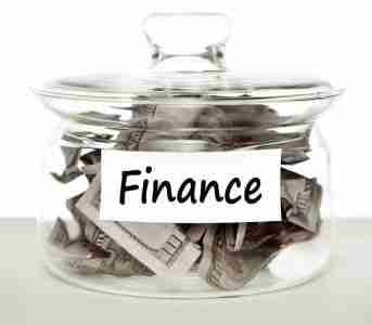 Loans Anyone Can Get Online A glass jar filled with crumpled currency bills and labeled with a tag reading "loans anyone can get.