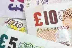 Assorted short term cash loans in British pound sterling banknotes.