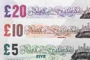 A selection of Bank of England notes including £20, £10, and £5 denominations, with intricate designs and the bank of England's header, often used for short-term payday loans.