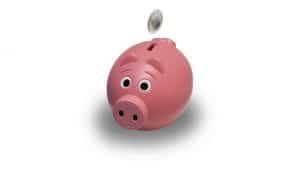 pink piggy bank coin being dropped in